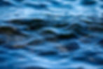 Blurred close-up of rippling blue open water.
