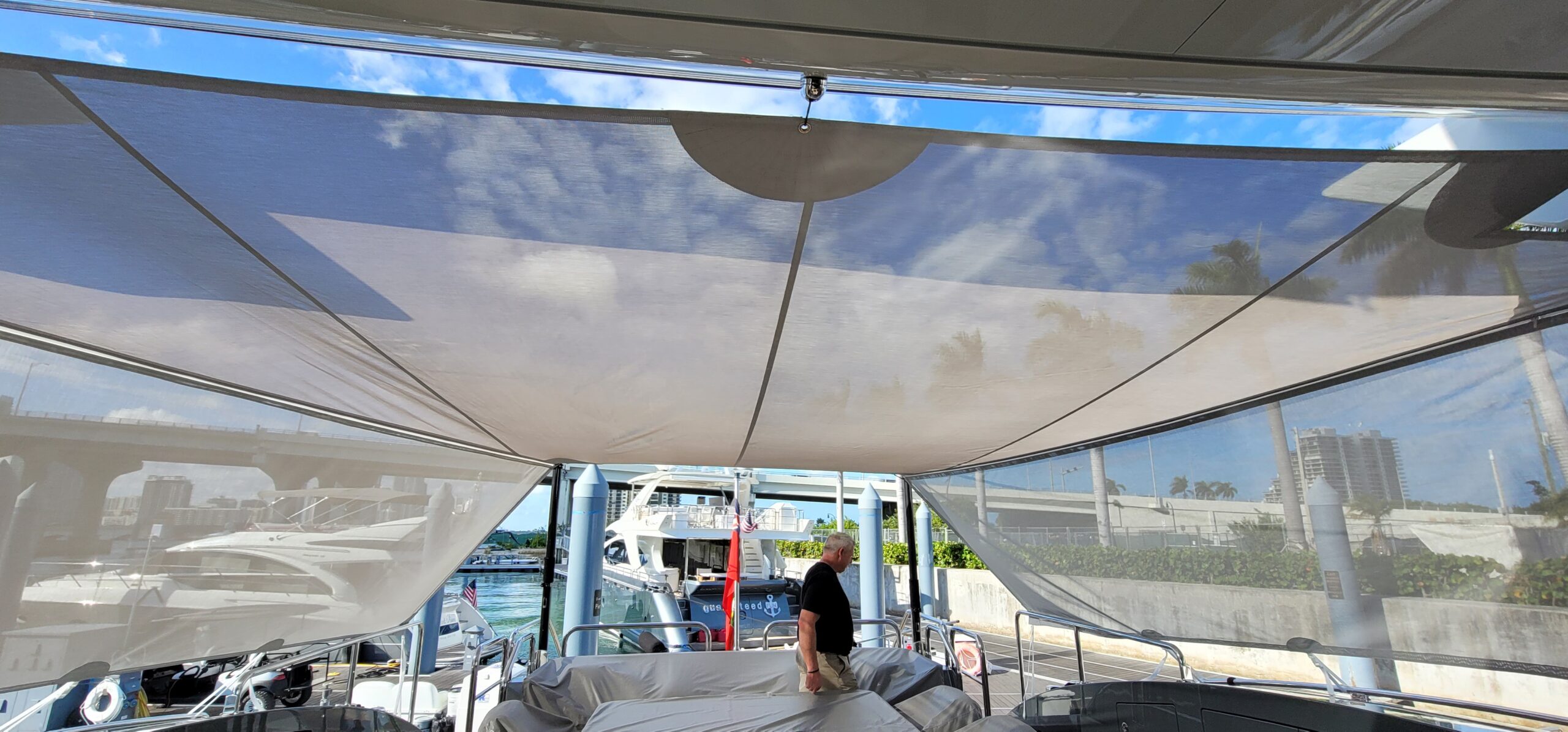 Mesh sun shade canopy over a yacht's deck at a Miami marina, Miami.