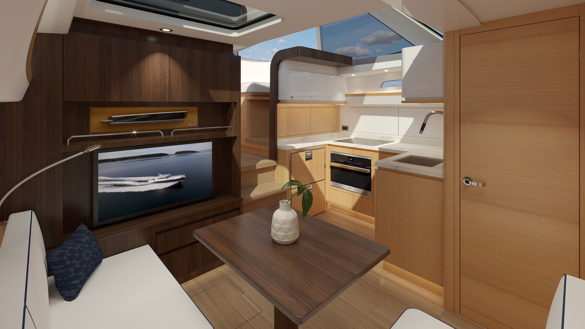 Rendered interior of a motor yacht salon showing a galley kitchen, dining table, and wood cabinetry, with the business name and town unknown.