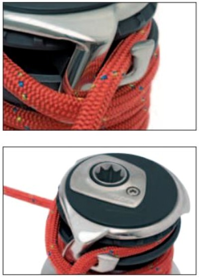 Red and blue-flecked sailing line wrapped around a stainless steel sailboat winch drum.