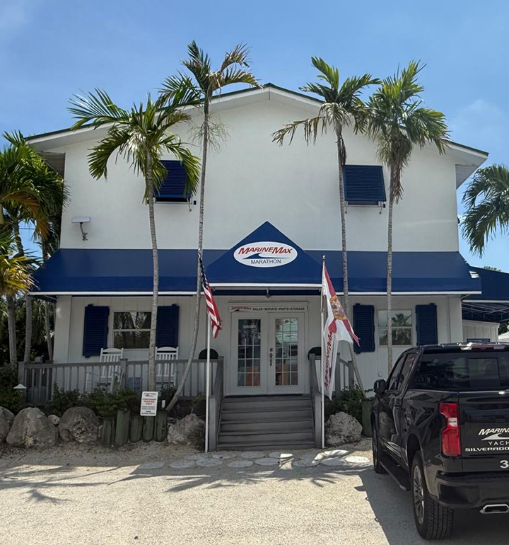 MarineMax dealership building with palm trees and flags at MarineMax, Marathon