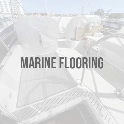 Marine flooring installed on a boat deck with covered seating and marina docks in the background.