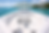 Blurred view of open water with white structures, location and business unknown.