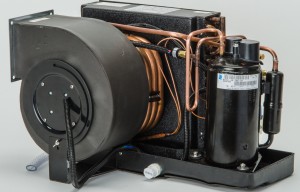 Compact marine-style air conditioning unit with blower, copper coils and compressor, shown without a business name or town.