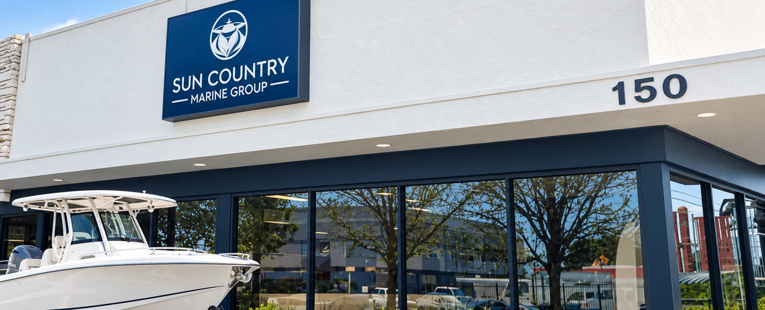 Center console boat displayed outside the Sun Country Marine Group storefront at 150, town not shown.