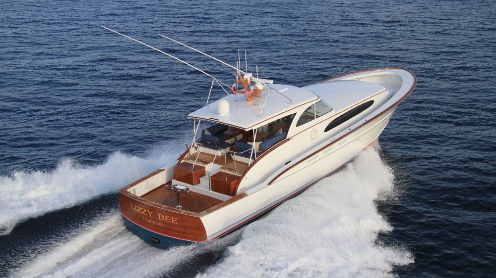 Lizzy Bee, a teak-decked sportfishing motor yacht with outriggers, underway at speed off Palm Beach.