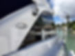 White boat bow and hull photographed close up against a blue sky.