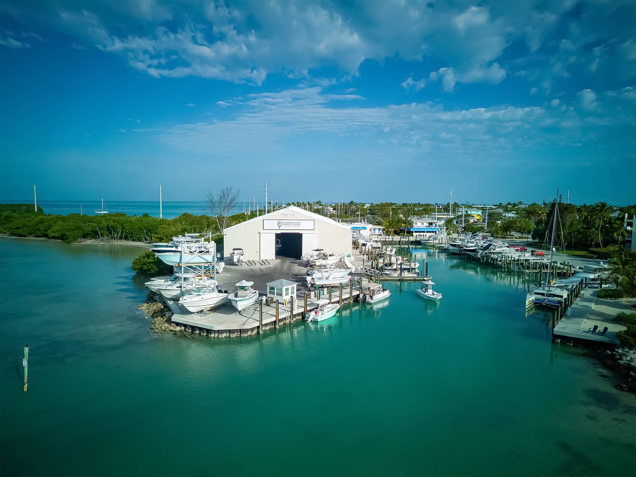 Aerial view of boat storage building and docked boats at Caloosa Cove Marina & Resort, Islamorada