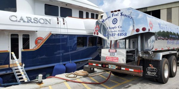 Fuel delivery truck from Marine Fuel Service & Supply Co. fueling the yacht Carson at a dock in Fort Lauderdale, Florida.