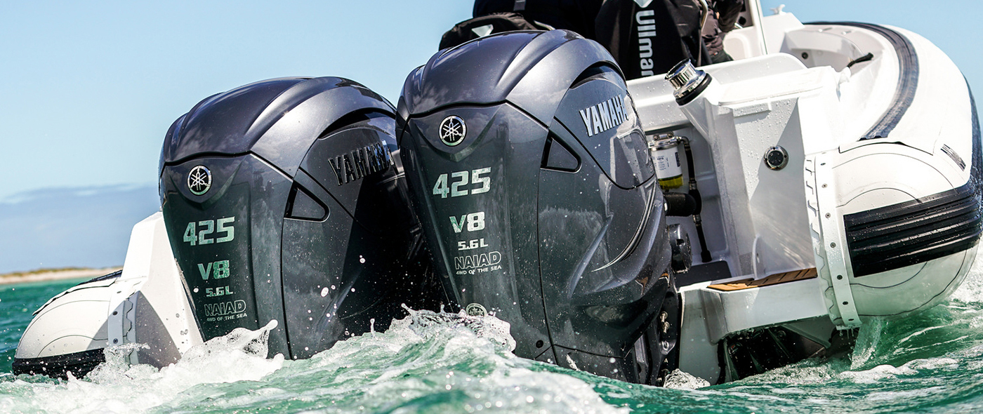 Twin Yamaha 425 V8 outboard engines powering a white rigid inflatable boat through choppy water.