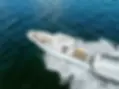 Aerial view of a white motorboat on dark blue water.