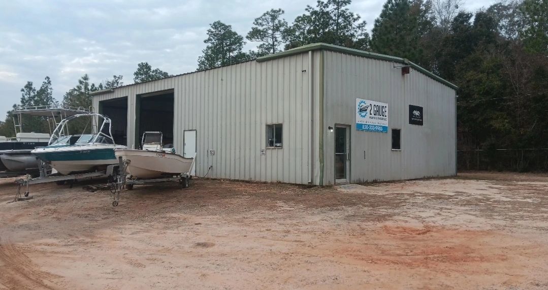 Metal workshop building with two boats on trailers at 2 Gauge Marine & Trailer.