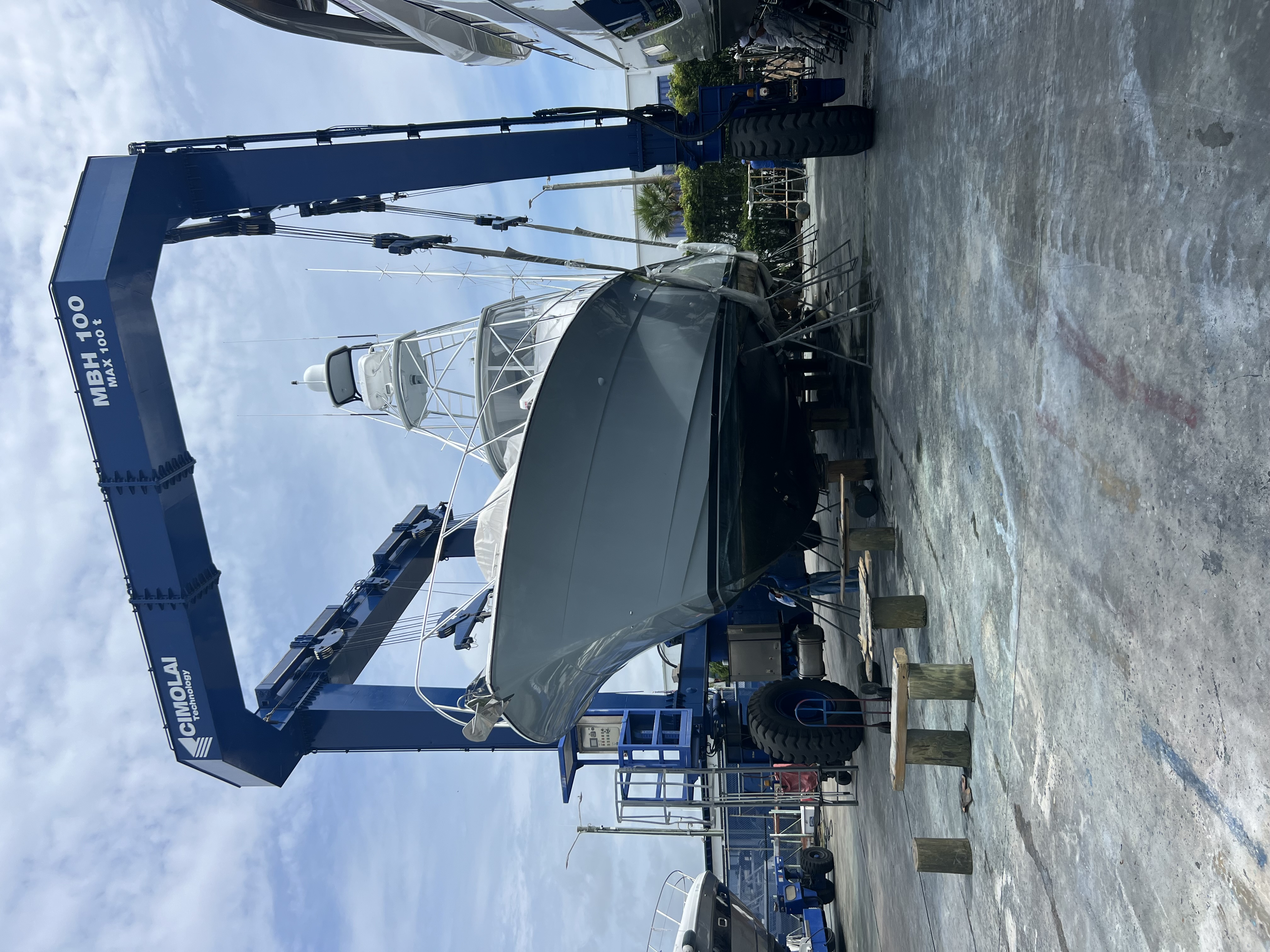 Sportfishing boat supported on a CIMOLAI MBH 100 travel lift at a boatyard, location not identified.