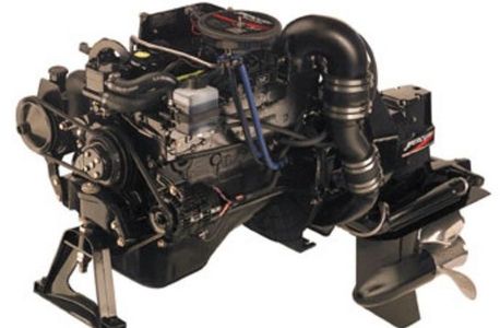 Marine inboard engine with stern drive and propeller shown on a stand, with no business name or town visible.