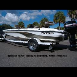 Nitro bass boat on a trailer with a Mercury outboard, showing carburetor rebuild, impeller change, and basic tune-up work.